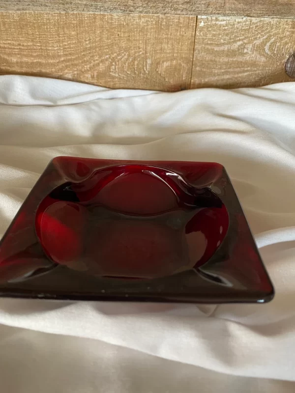 Red glass ashtray vintage 1970s ruby red closeup