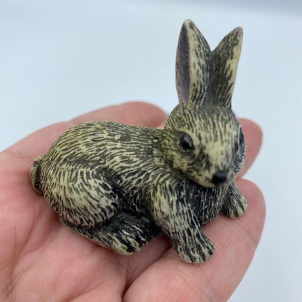 vintage soapstone carvings in hand to show size of bunny rabbit