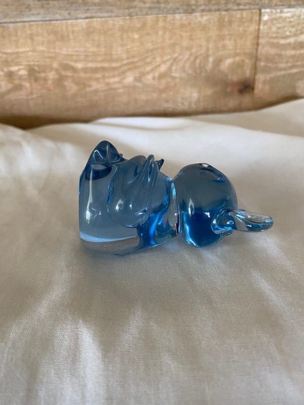 koala bear figurine laying side view blue glass