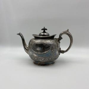 silver plate tea pot embossed from the 1880s Thomas Otley left side