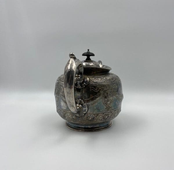 silver plate tea pot embossed from the 1880s Thomas Otley handle