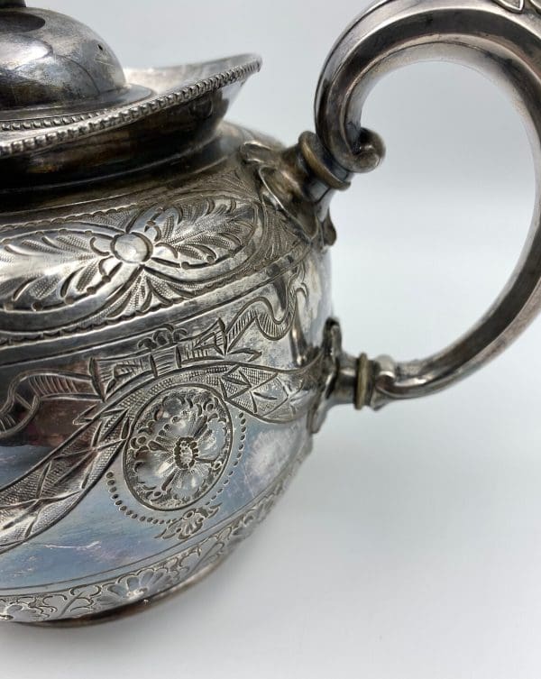 silver plate tea pot embossed from the 1880s Thomas Otley close of etched design