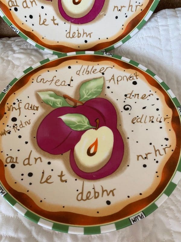 vintage decorative wall plates close of another with the same plum design