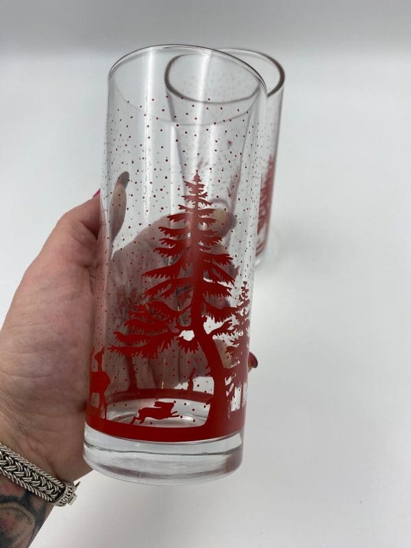 vintage glasses with red trees in hand to show size