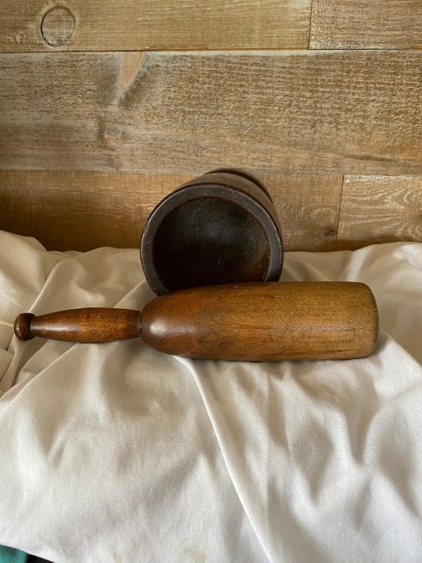 vintage wood mortar and pestle laying on side