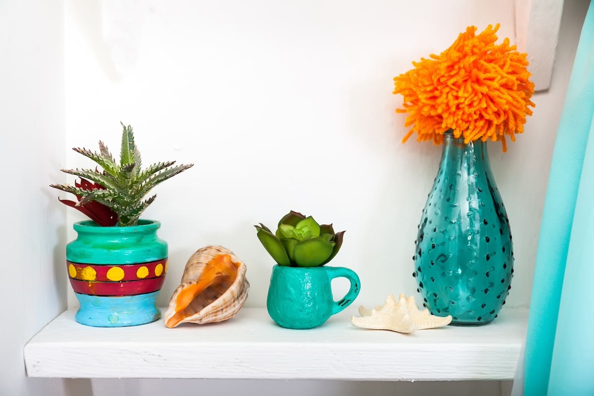 Vintage decoration items in green on a white shelf