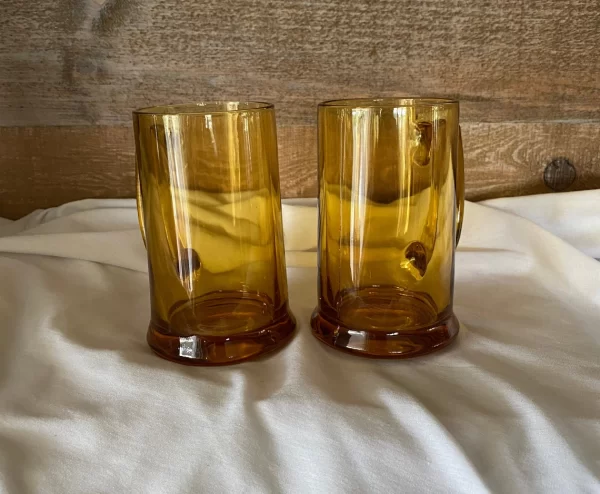 glass beer mugs handle behind pair