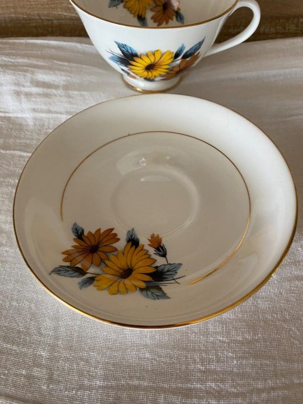 flowered tea cups Black Eye Susan top of saucer showing gold detail on edge and middle