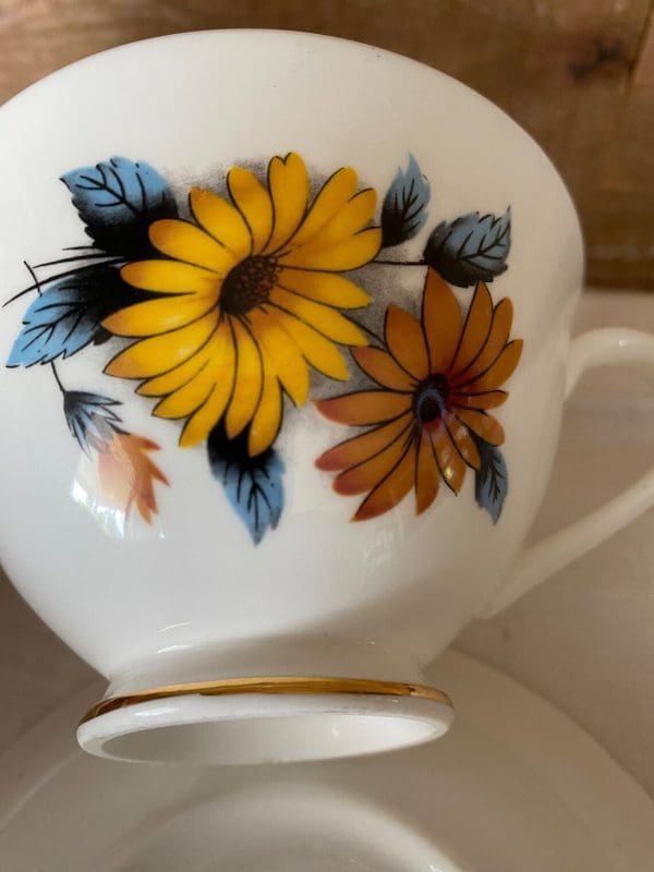 flowered tea cups Black Eye Susan close to flowers on front of teacup