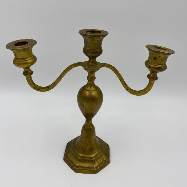 vintage brass candelabra close holds three candlesticks