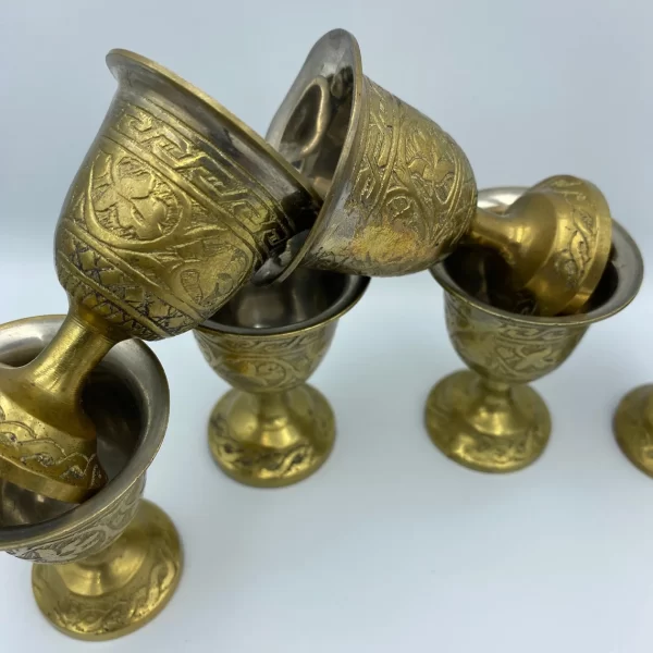 brass shot glasses close showing molded brass