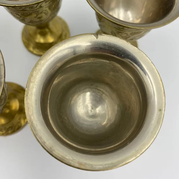 brass shot glasses close inside showing stainless lined