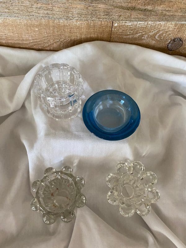 vintage glass candle holder top view of all, one pair, one blue glass, one crystal