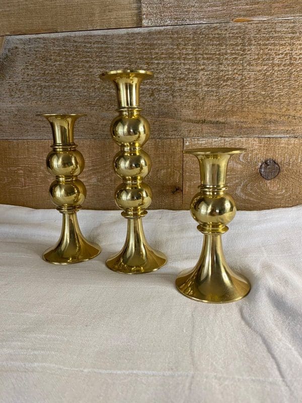 vintage brass candle holder set of three showing medium with two balls, large with three, and small with one