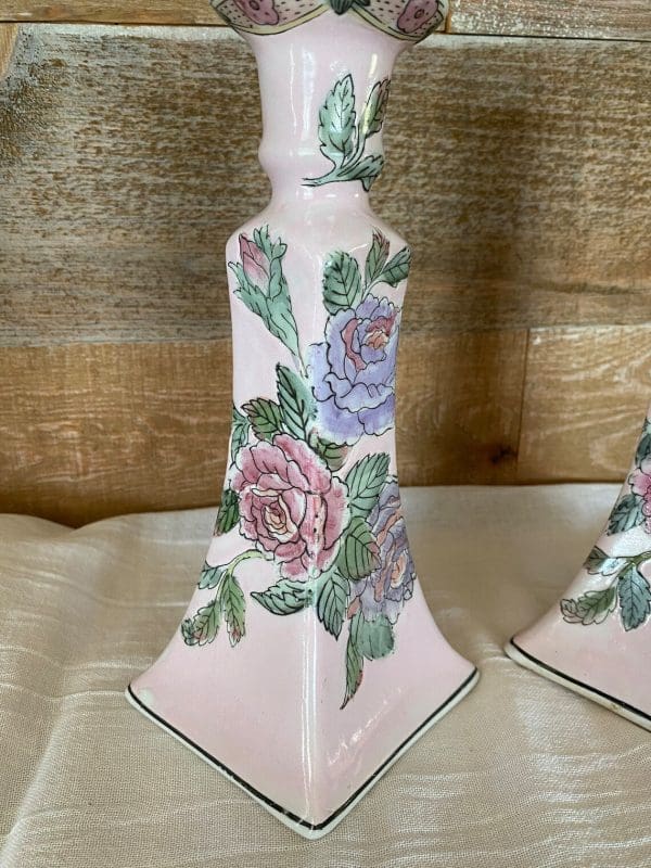 pink ceramic candle holder close of one from set showing floral design in pink and violet