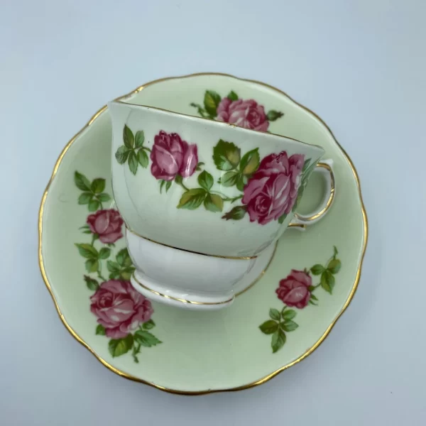 mint green tea cups Colclough Green Tea Cup and Saucer with Pink Roses tea cup laying on saucer showing off the pattern