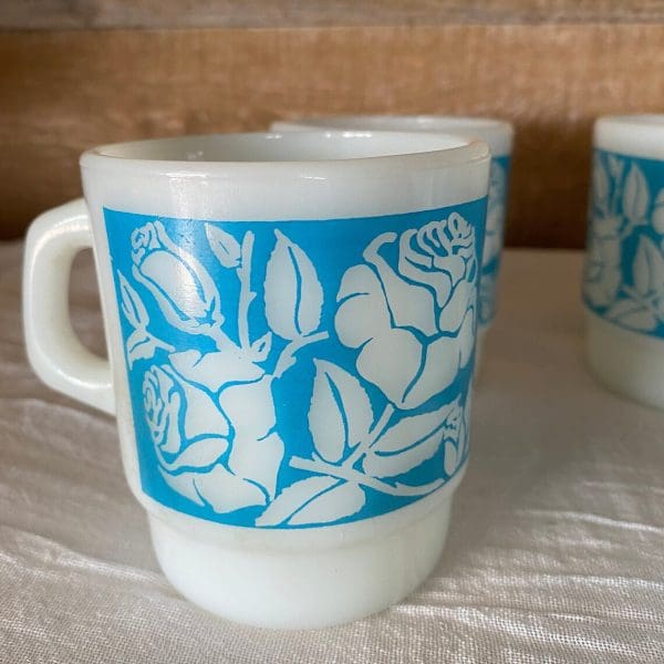 Fire King milk glass mug blue with white flowers close of one of four