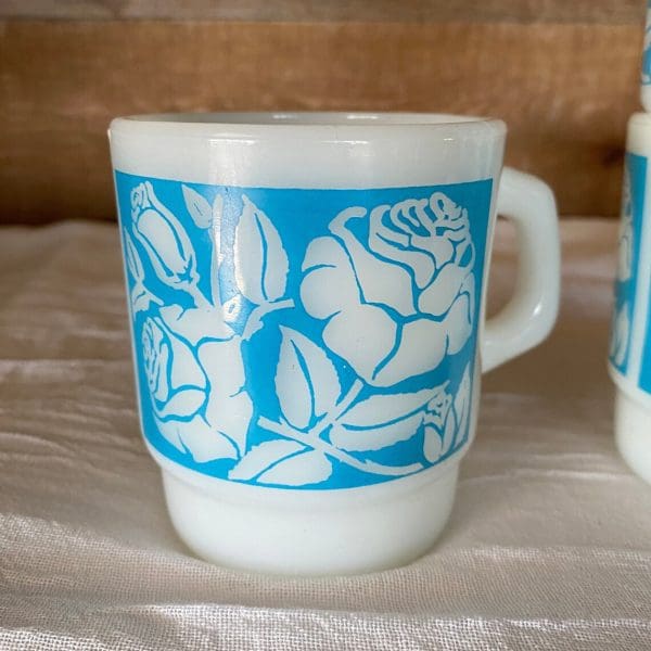 Fire King milk glass mug blue with white flowers close two of four