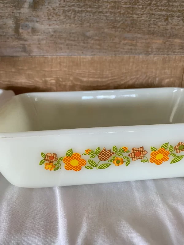 Fire king loaf pan Gingham Flowers Plaid orange yellow red green on milk glass close left