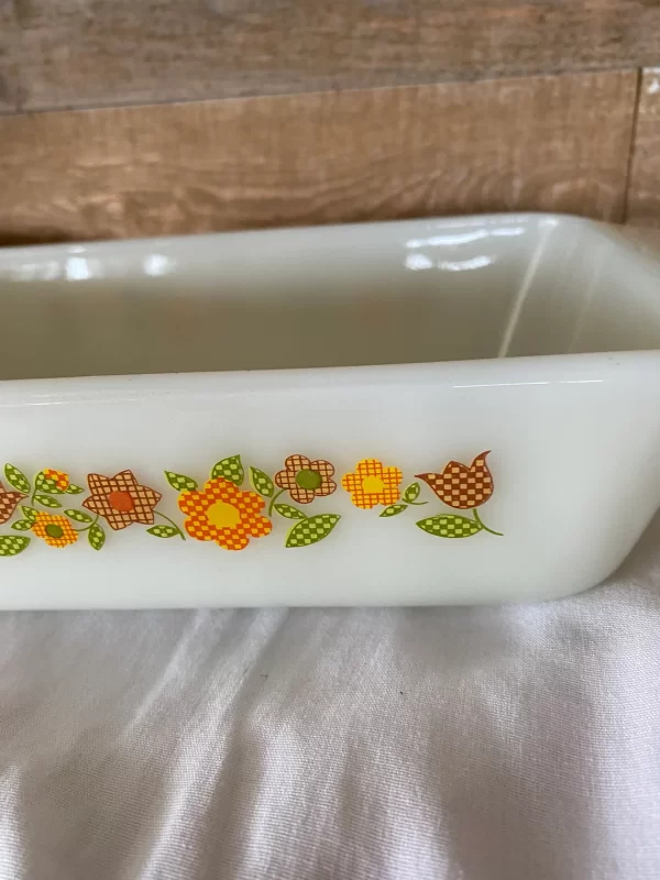 Fire king loaf pan Gingham Flowers Plaid orange yellow red green on milk glass retro pattern close