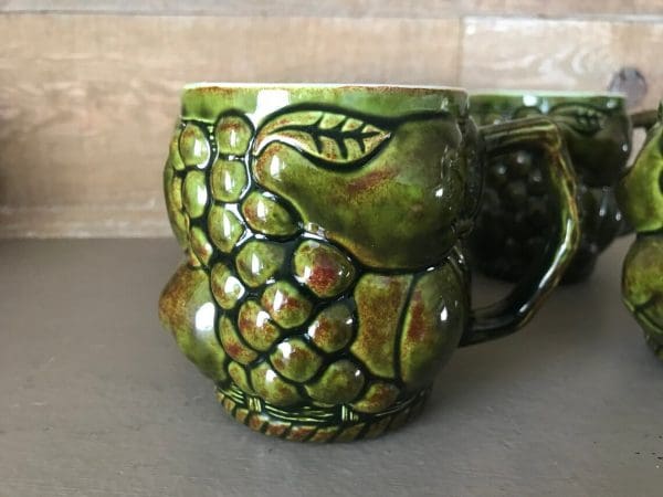 green coffee mugs grapes pears fruit decor