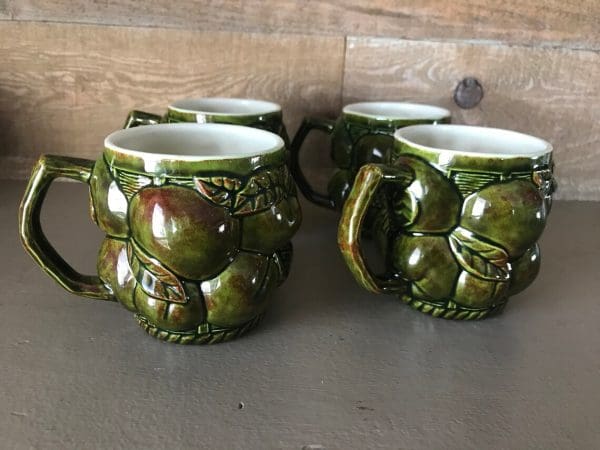 green coffee mugs fruit left side