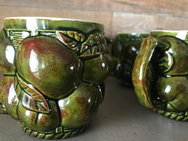 green coffee mugs close shaded with red