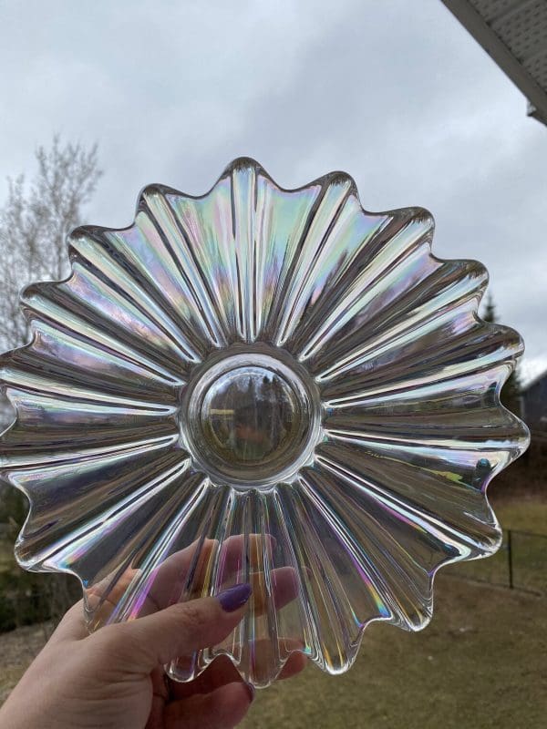 clear carnival glass bowl held in light outside