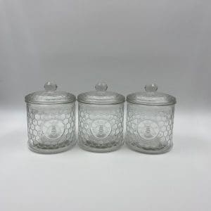 honeycomb canister with honey bee on front clear embossed glass front next to each other