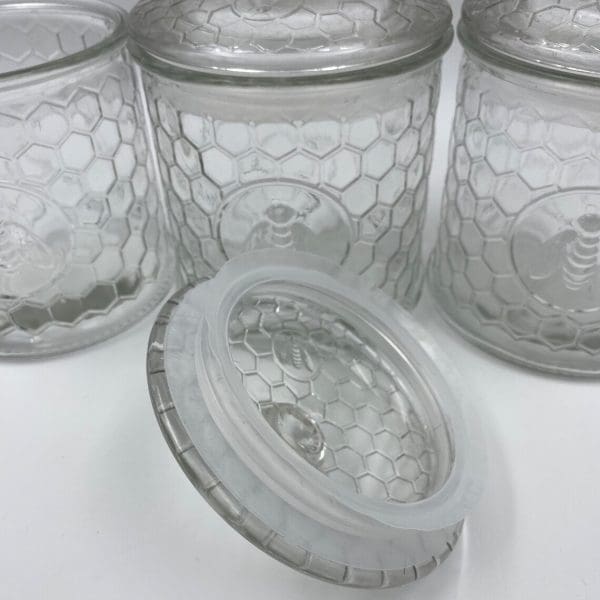 honeycomb canister with honey bee on front clear embossed glass inside plastic seal