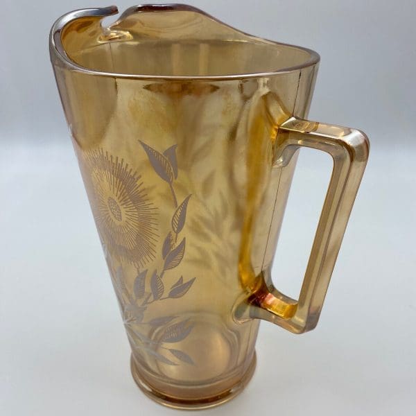 vintage carnival glass pitcher close to show orange marigold color