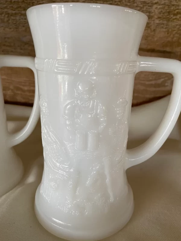 milk glass stein pair with embossed detailed design of tavern