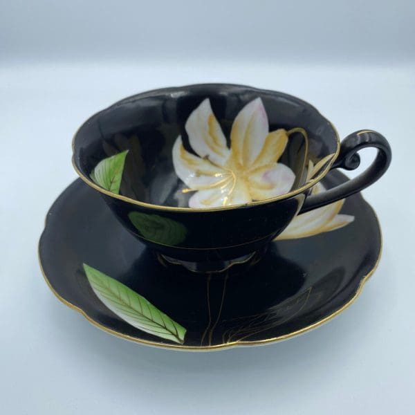 Occupied Japan tea cup and saucer black with lily flower right side