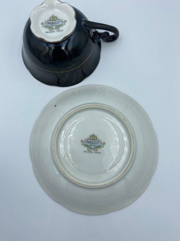 Occupied Japan tea cup and saucer black with lily flower bottom