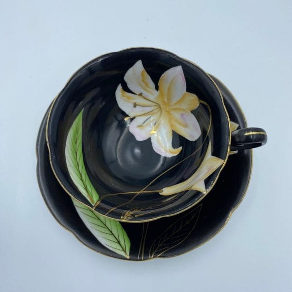 Occupied Japan tea cup and saucer black with lily flower top