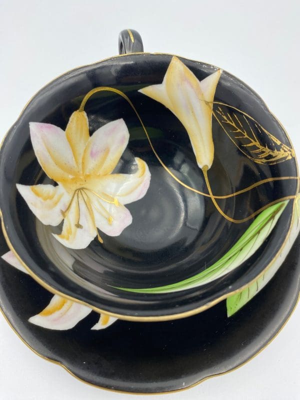 Occupied Japan tea cup and saucer black with lily flower gold detail