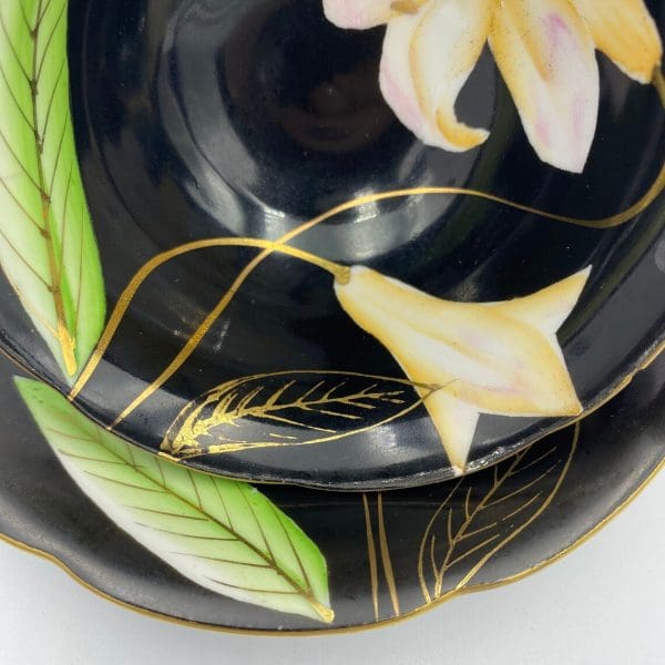 Occupied Japan tea cup and saucer black with lily flower close to gold detail