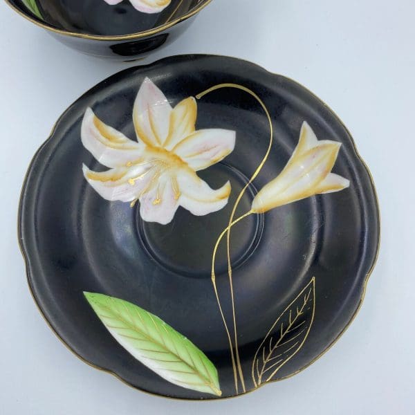 Occupied Japan tea cup and saucer black with lily flower saucer top