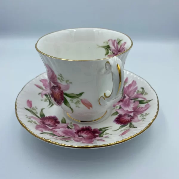 Paragon tea cup and saucer pink flowers hand facing showing gold trim