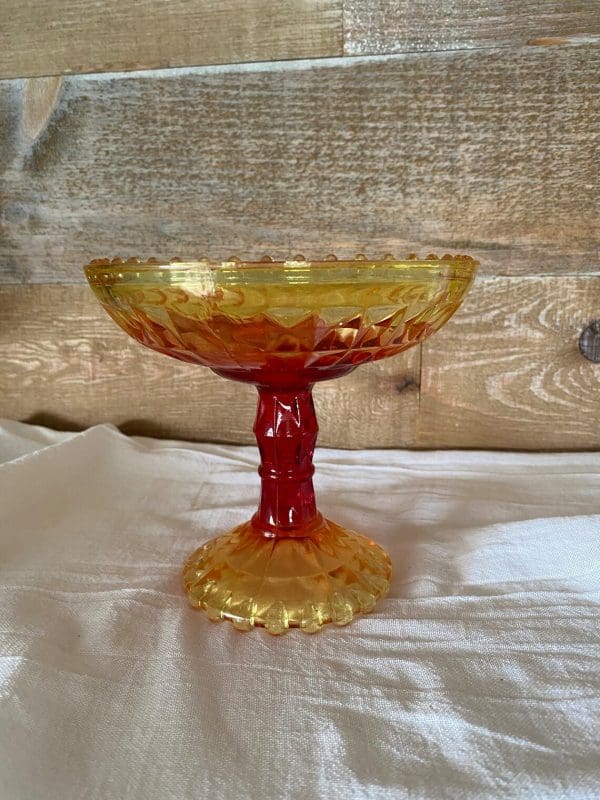 red and yellow glass candy dish side view