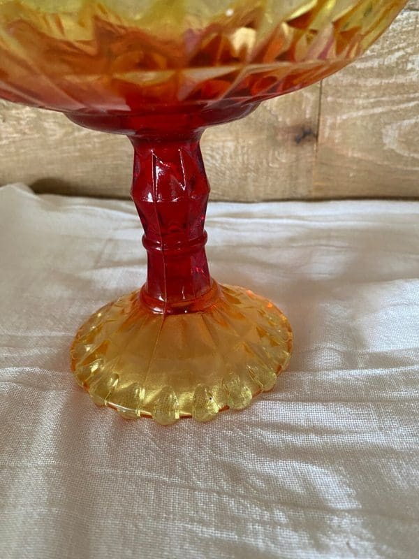 red and yellow glass candy dish red stem