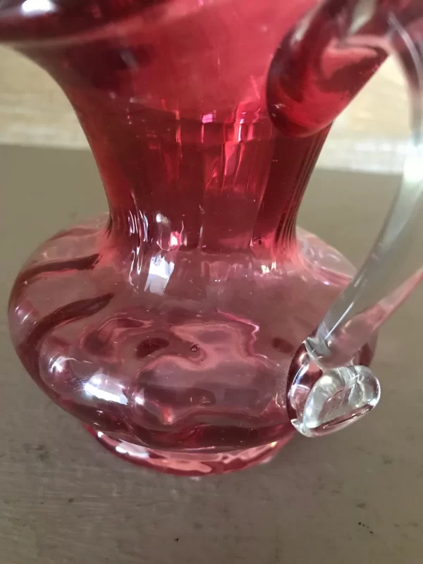 pink glass creamer with clear handle