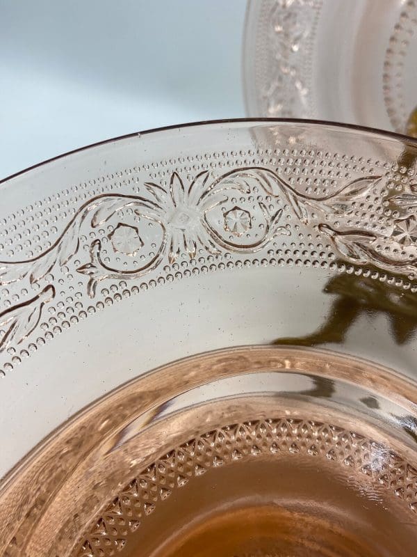 pink glass plates close to show embossed design