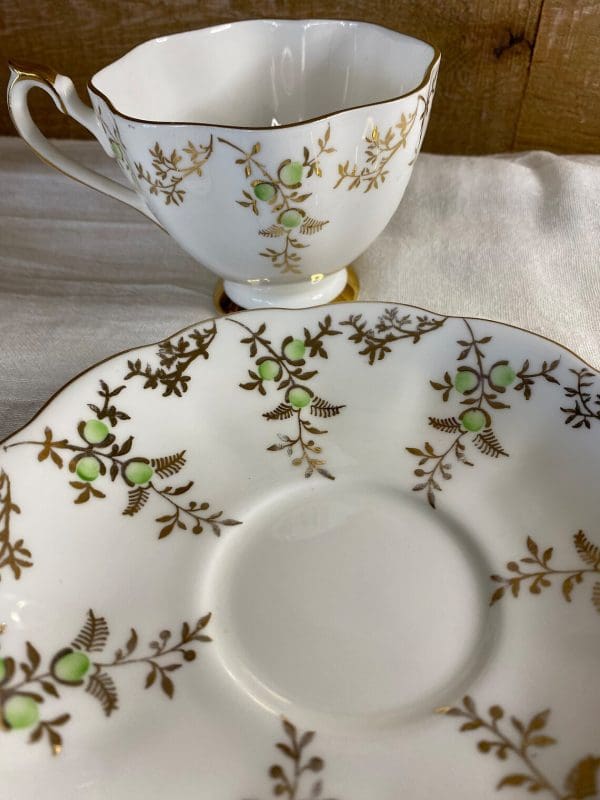 Queen Anne Cup and Saucer White Gold and Green pattern 5634 close to show wear on gold