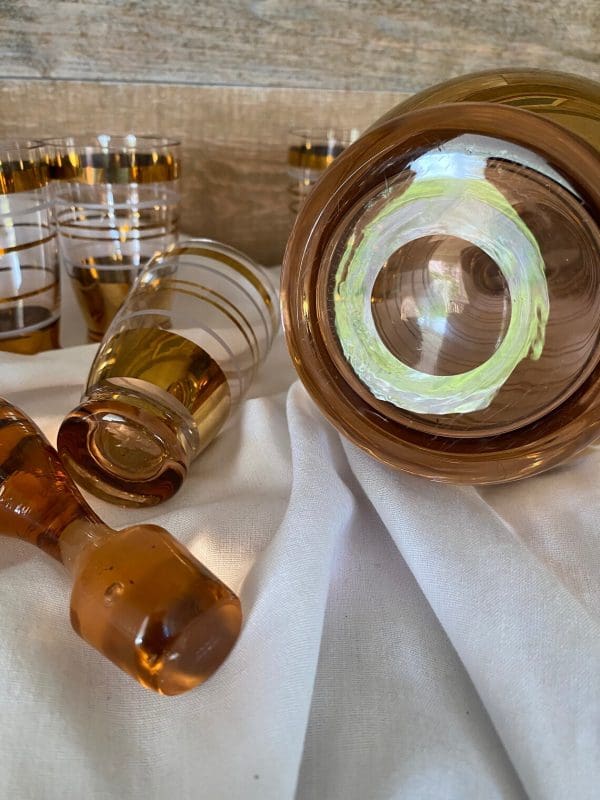 amber glass decanter with stopper gold and white stripes and four matching cups bottom