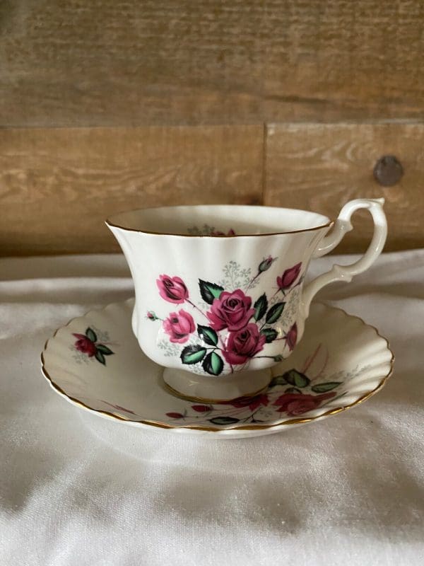 Royal Albert Montrose shape tea cup and saucer deep pink roses right side white background