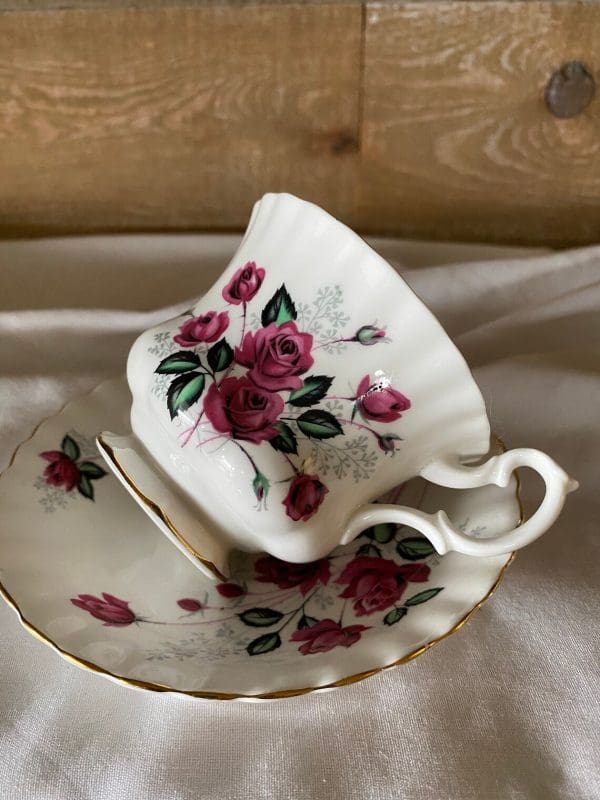 Royal Albert Montrose shape tea cup and saucer deep pink roses on side