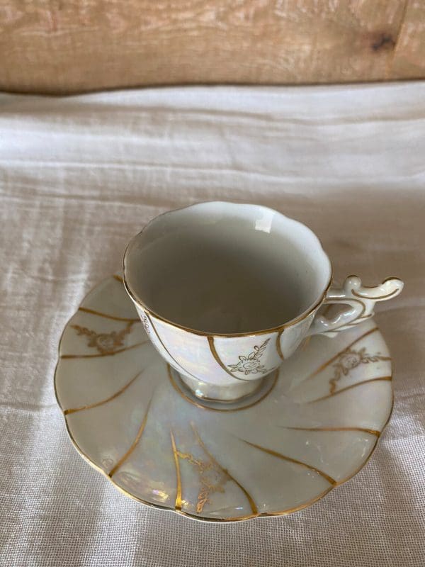 demitasse tea cups small iridescent white with gold top view