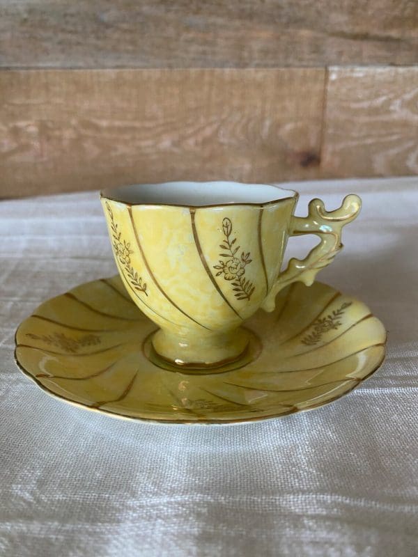 demitasse tea cups and saucers close yellow and gold floral design