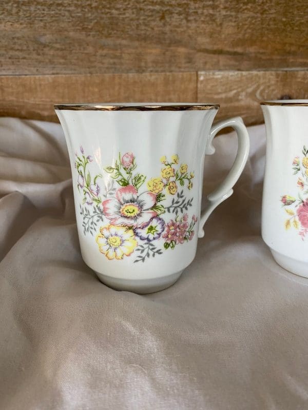 vintage white coffee mugs with floral design left mug